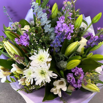 Lavender Dreams Bouquet - A serene hand-tied bouquet in shades of purple and white featuring fragrant stock, white chrysanthemums, freesia, lily buds and eucalyptus. Calming and fresh with a beautiful scent — a soothing choice for any occasion.