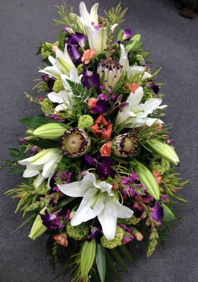 Native Harmony Spray - A striking funeral spray with natural textures and vibrant tones, thoughtfully designed to honour a cherished life.