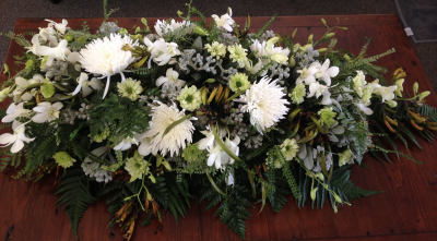 Pure Serenity Casket Spray - A graceful casket spray in soft, elegant tones, creating a peaceful and heartfelt farewell.