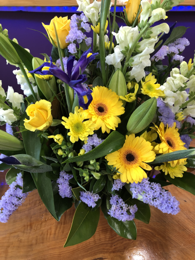 Golden Sunshine - A cheerful arrangement bursting with vibrant yellow and blue tones, designed to bring warmth, happiness and smiles to any occasion.
