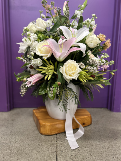 Blush Elegance - A graceful arrangement in soft blush and ivory shades, expertly designed to bring beauty, comfort and elegance to any occasion.