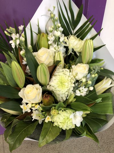 Pure Serenity - A timeless hand-tied bouquet in crisp white and fresh green tones, carefully arranged to create a sophisticated and calming display.